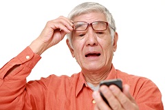 Older Man Looking at Cellphone with Surprise  thumbnail image